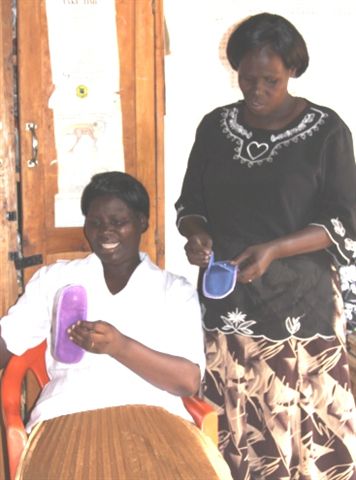 Kaluoki village teachers examining moon pads.  These will help teenage girls stay in school every month.